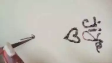 Nude girl puts henna on her naked body during a video call sex